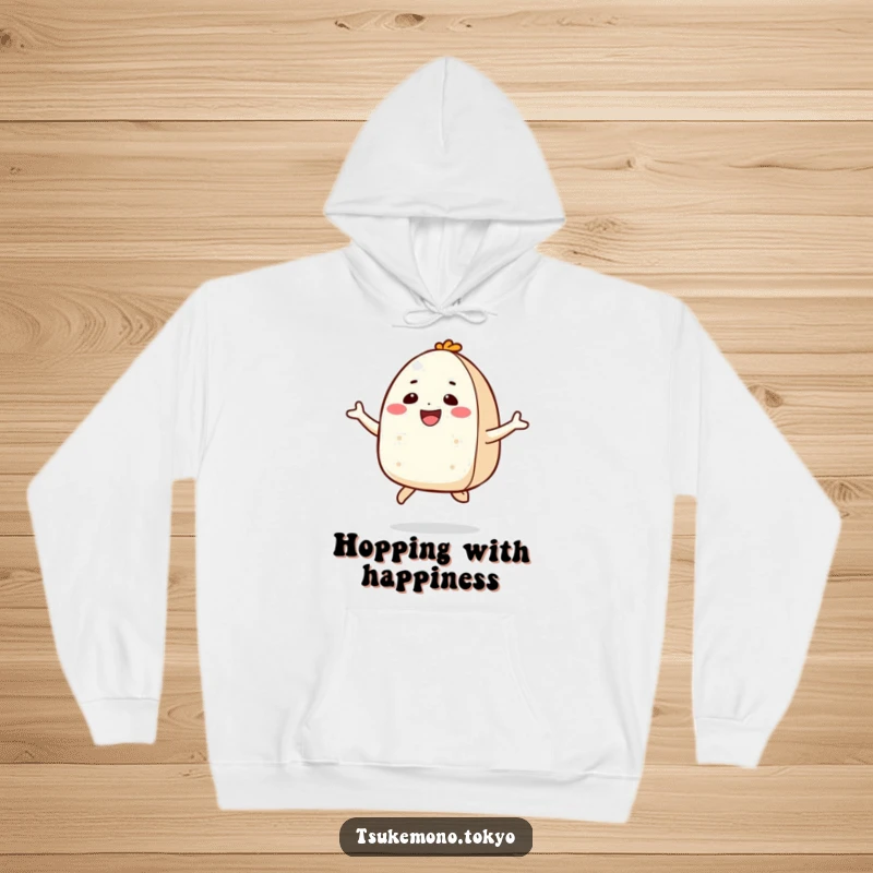 Funny hoodie with a smiling onigiri character in a joyful jump, offering warmth and a vibe of pure happiness.