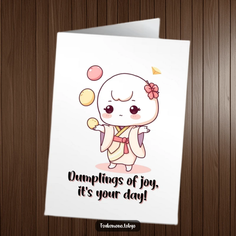 Funny Free Printable Birthday Card: Adorable mochi character in pastel kimono juggling colorful dumplings with a playful expression.